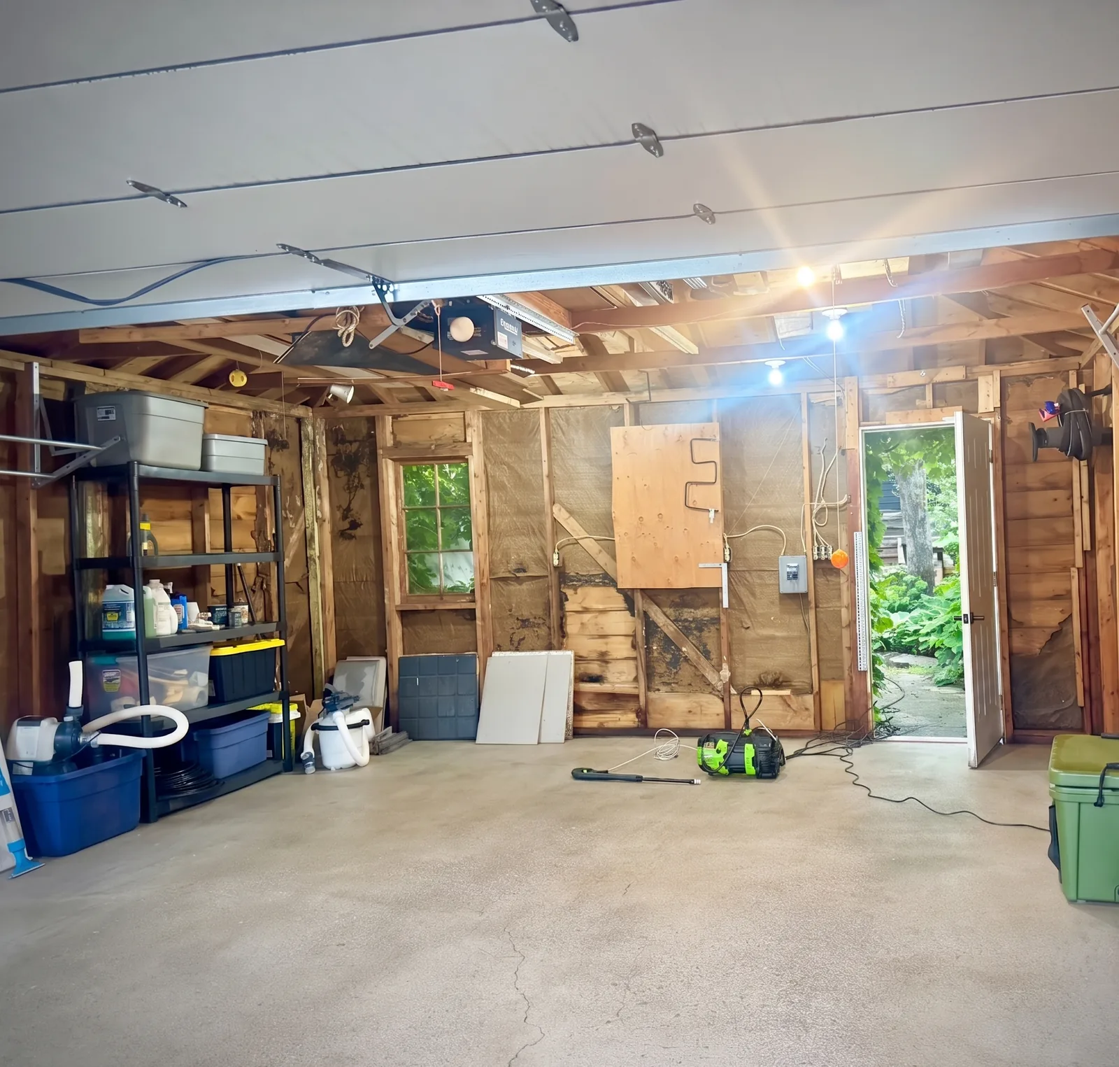 Detached Toronto garage after cleanout — emptied, swept to clean concrete, items stored